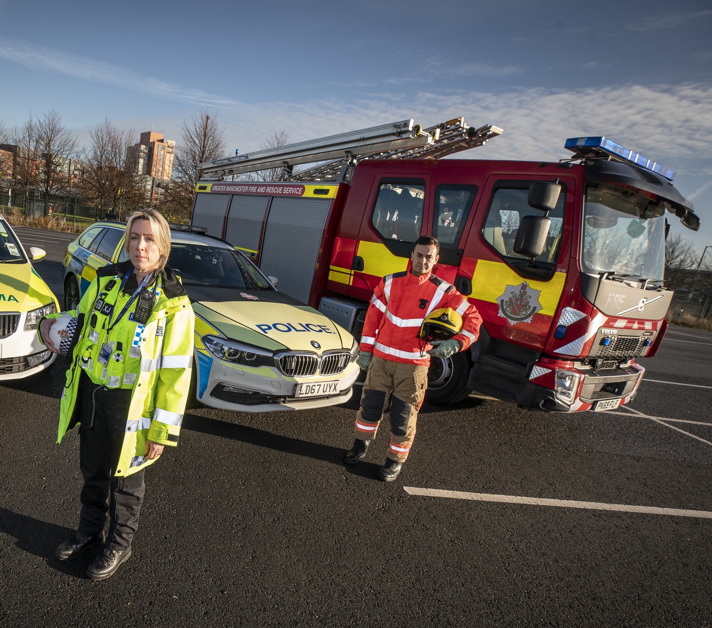 Police woman and fireman with vehicles